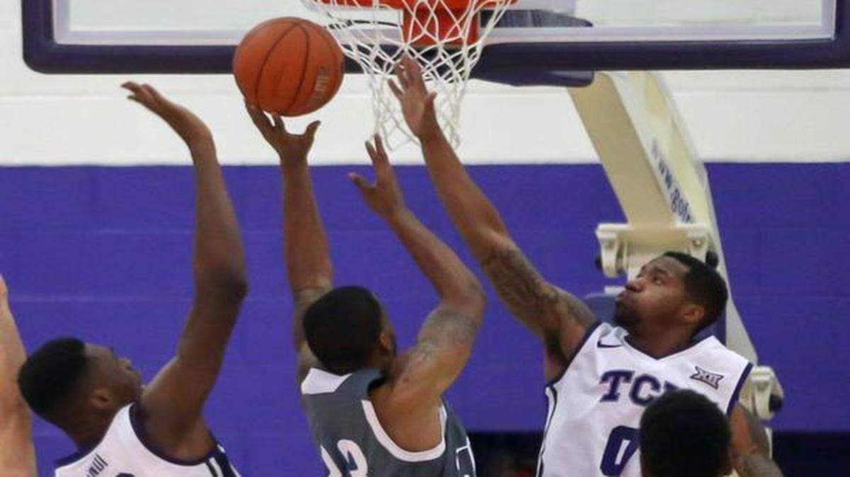 
Defense has been key in TCU’s 13-0 start. TCU’s Link Kabadyundi (22) and Charles Hill Jr. (0) were all over Tennessee State’s Christian Crockett on Monday.


