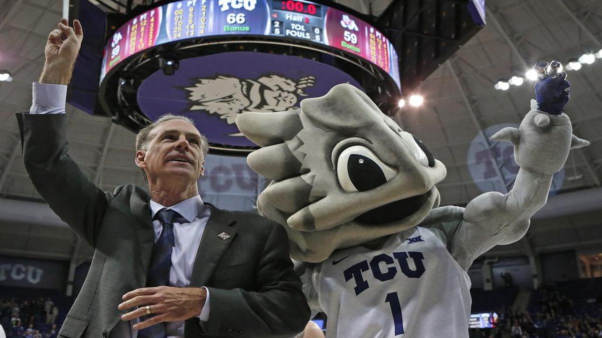 TCU coach Jamie Dixon and Super Frog stand for the school song after the Horned Frogs beat Fresno State in the National Invitational Tournament in March.