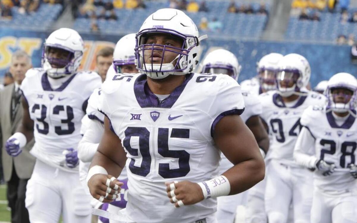 TCU defensive tackle Aaron Curry takes the field with teammates Saturday at Milan Puskar Stadium in Morgantown ahead of the Horned Frogs’ game against West Virginia.