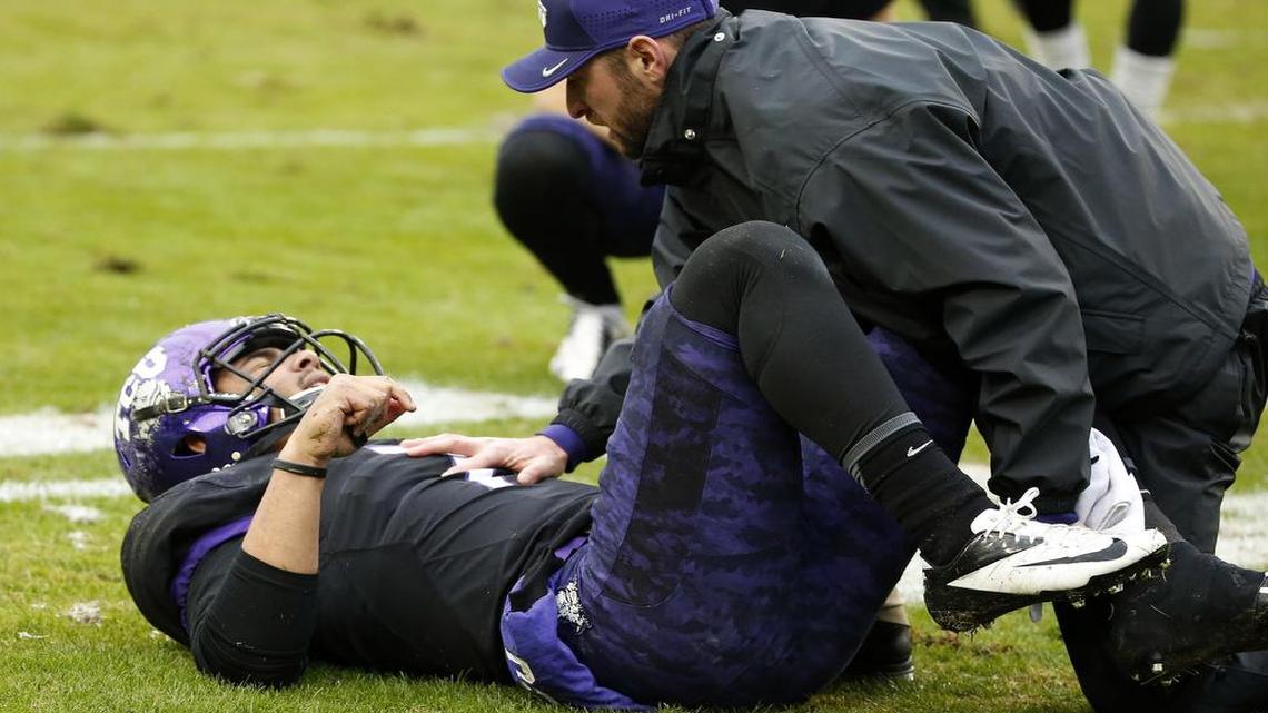 TCU quarterback Kenny Hill is attended to on the field following a play in the fourth quarter of a Dec. 3 game against Kansas State at Amon G. Carter Stadium.