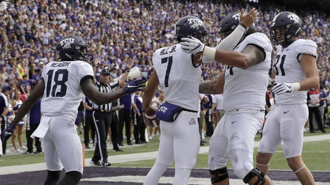 TCU quarterback Kenny Hill is greeted by teammates after scoring on a 7-yard scramble in the first quarter at Kansas State. It was one of three touchdown runs by the Horned Frogs on Saturday.