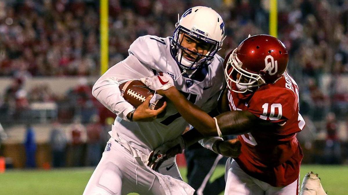 TCU quarterback Kenny Hill Jr. tries to fight off Oklahoma defensive back Steven Parker the Horned Frogs’ 38-20 loss to the Sooners in Norman, Okla., on Nov. 11.