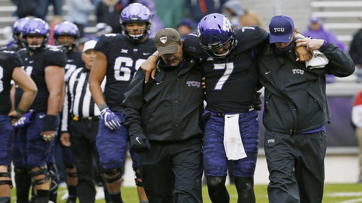 TCU quarterback Kenny Hill is helped off the field after an injury in the final minute of a Dec. 3 game against Kansas State. Coach Gary Patterson said Tuesday that Hill has returned to practice as TCU prepares for the Liberty Bowl.