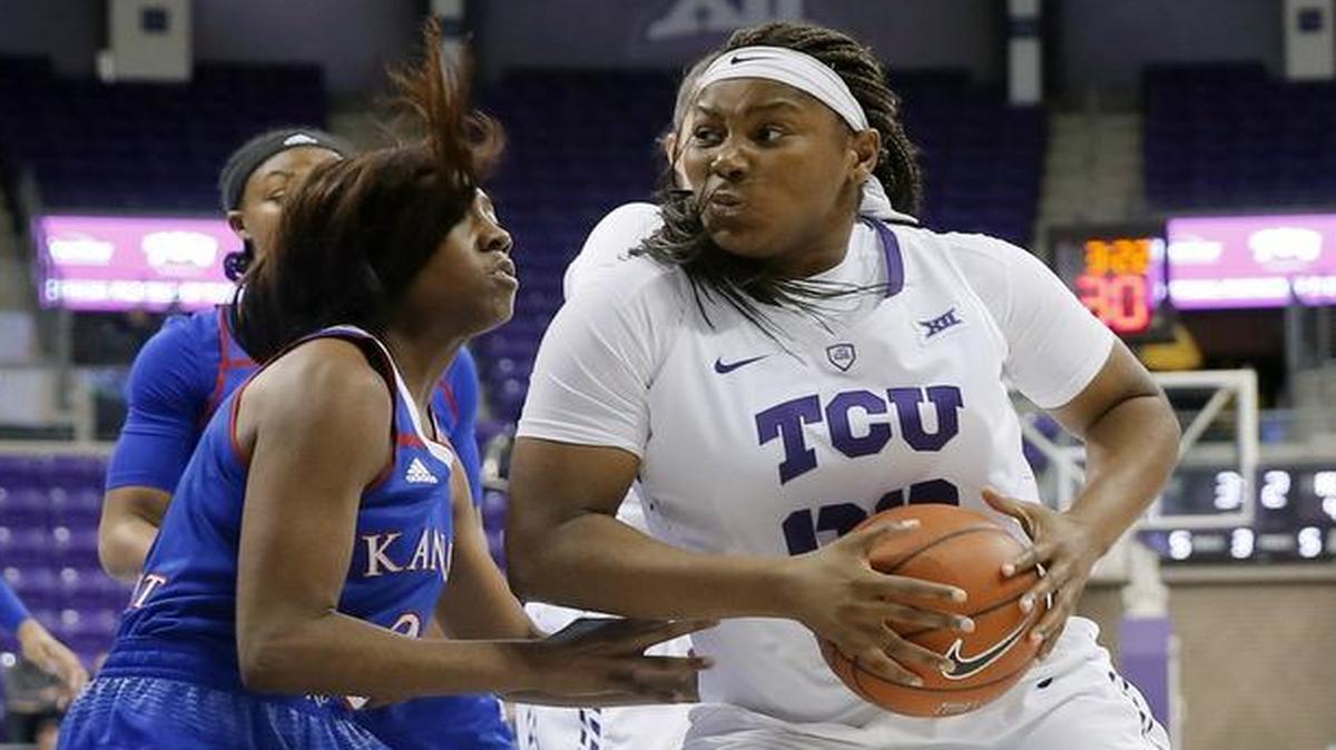 TCU forward Amy Okonkwo muscles into the defense of Kansas guard McKenzie Calvert during the Horned Frogs’ 84-66 victory over Kansas on Sunday.