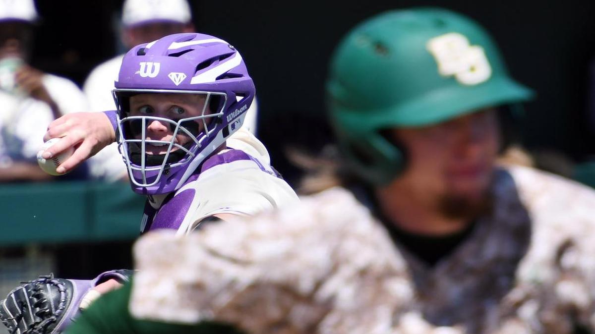 TCU catcher Evan Skoug aims for a throw to first base to retire Baylor hitter Davis Wendzel during the seventh inning of Sunday’s game at Lupton Stadium.