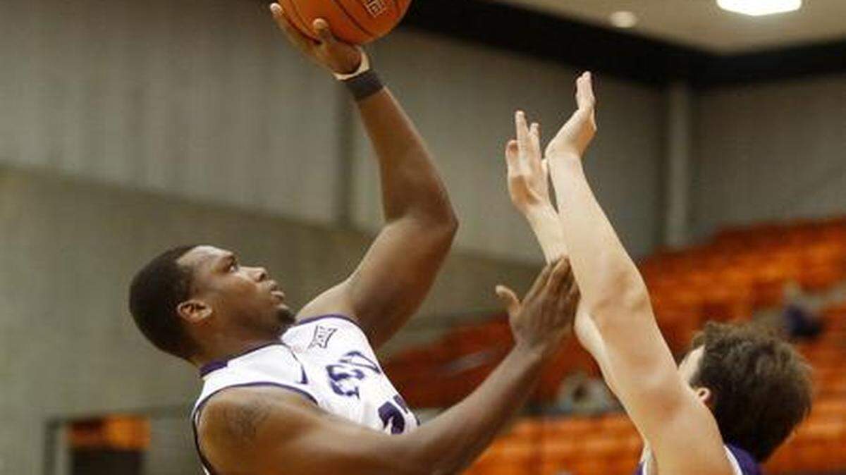 
TCU forward Devonta Abron (23) shoots over Furman’s Geoff Beans (3) in a game on Dec. 9 at Wilkerson-Greines Activity Center. 
