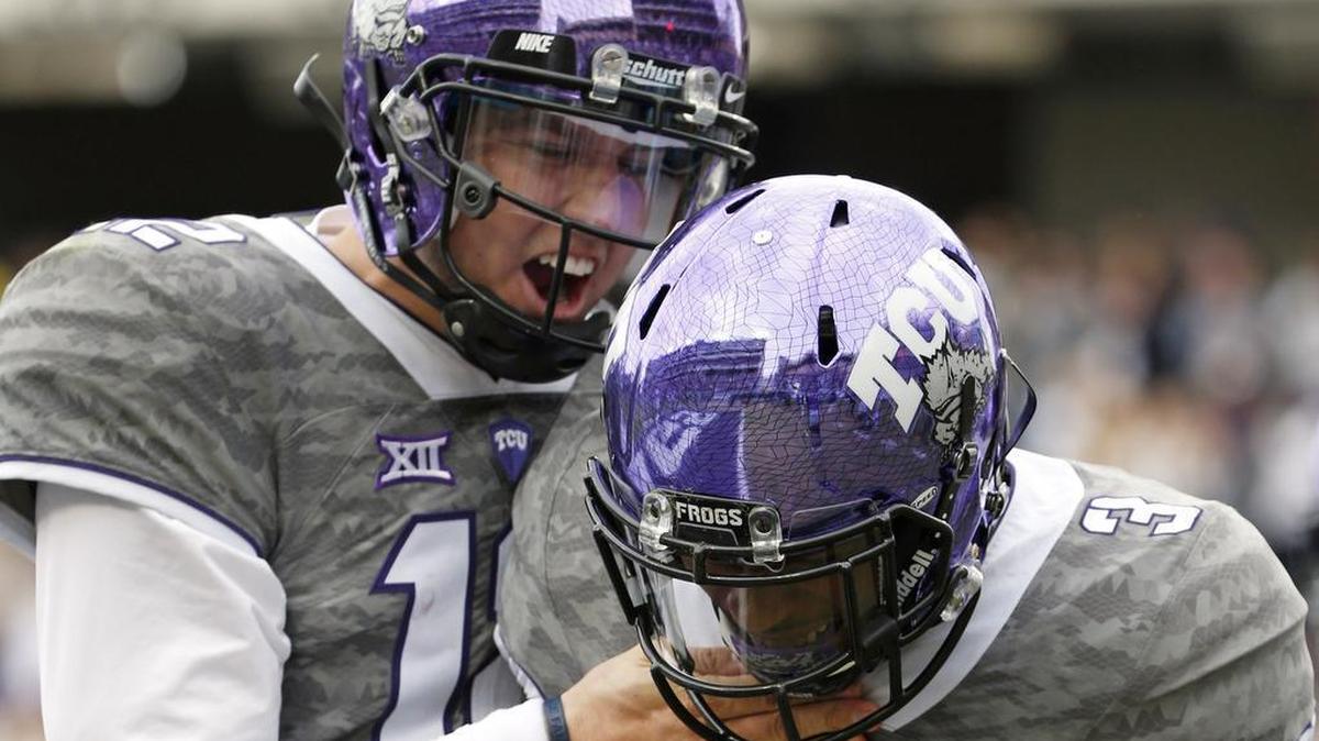 TCU quarterback Foster Sawyer celebrates with running back Shaun Nixon after they connected on a 42-yard touchdown pass. It gave the Horned Frogs a 20-10 lead in the fourth quarter.