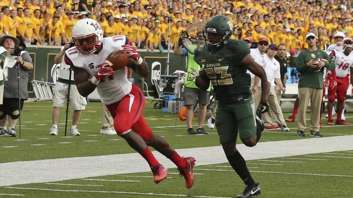 Liberty wide receiver Antonio Gandy-Golden, left, scores past Baylor safety Jourdan Blake, right, in the first half Saturday’s game at McClane Stadium in Waco.