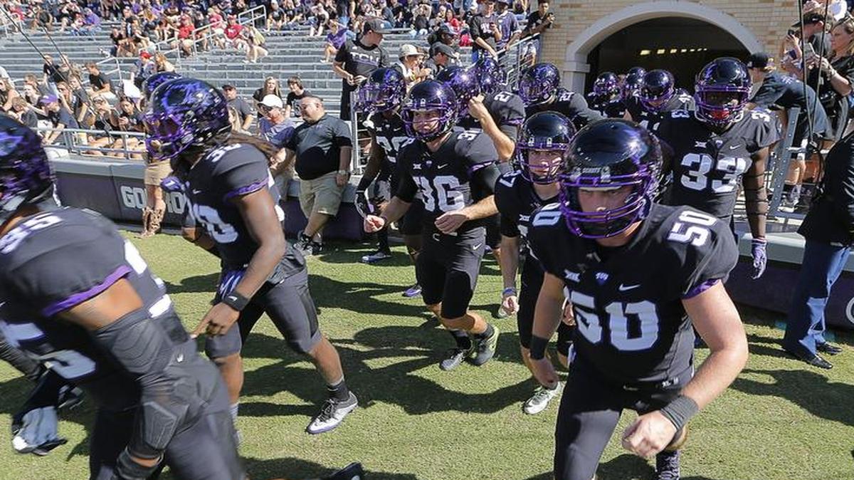 TCU players run out for pregame activities at Amon G. Carter Stadium at the Oct. 1 game against Oklahoma.