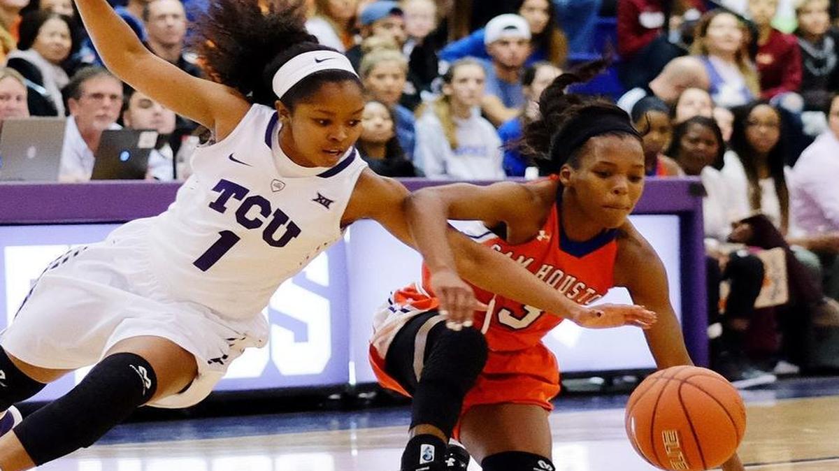 Texas Christian University sophomore guard Toree Thompson, 1, and Sam Houston State University senior guard Shernise Robertson, 3, fight for the ball.
