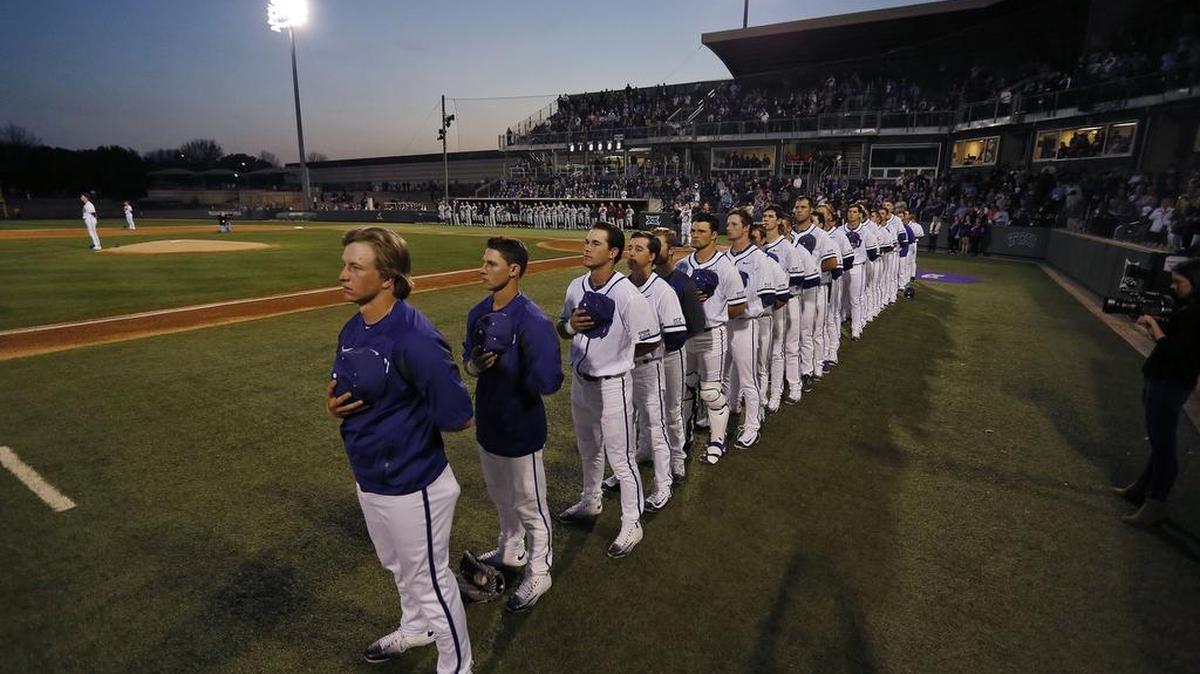 The TCU baseball team listens to the national anthem before the season opener Feb. 19 against Loyola Marymount at Lupton Stadium.