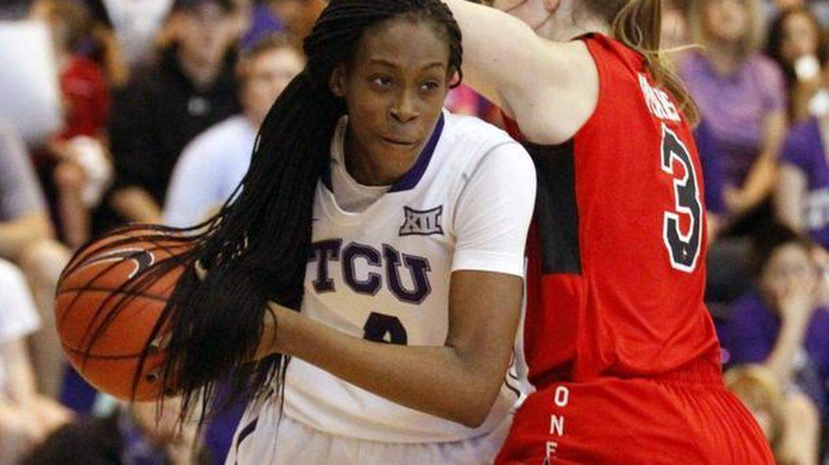 
TCU forward Chelsea Prince (4) looks to pass under Texas Tech guard Minta Spears (3) on Feb. 8. 
