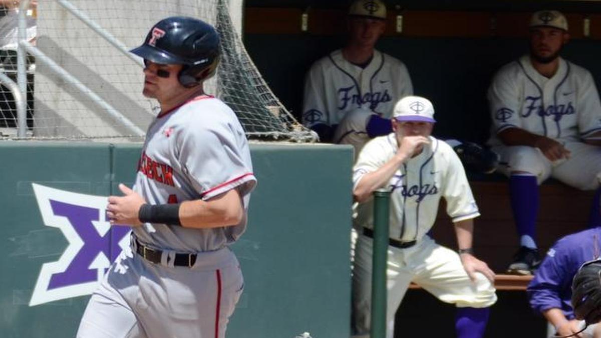 Texas Tech’s Cory Raley crosses home plate after a wild pitch by reliever Sean Wymer, as coach Jim Schlossnagle looks on from the TCU dugout. The score helped Texas Tech win the game 3-1 and the series 2-1.
