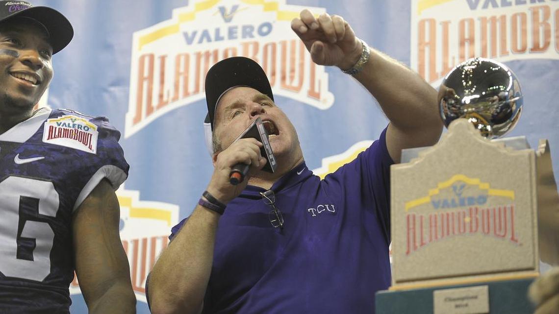 TCU coach Gary Patterson calls out to fans in the postgame celebration at the Alamo Bowl on Jan. 2, 2016, in San Antonio as safety Derrick Kindred looks on. The Horned Frogs had just completed a rally from a 31-0 halftime deficit to defeat Oregon 47-41 in three overtimes.
