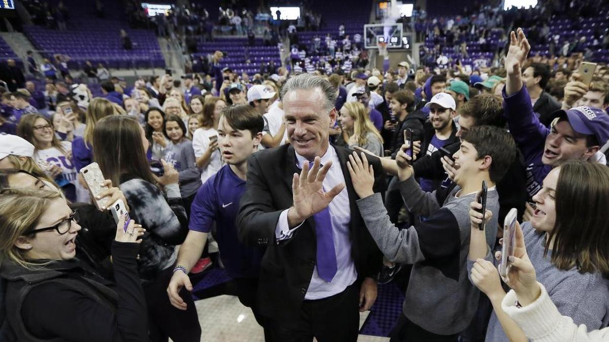 TCU coach Jamie Dixon is congratulated by fans after a 82-73 win over No. 7 West Virginia Monday night at Schollmaier Arena.