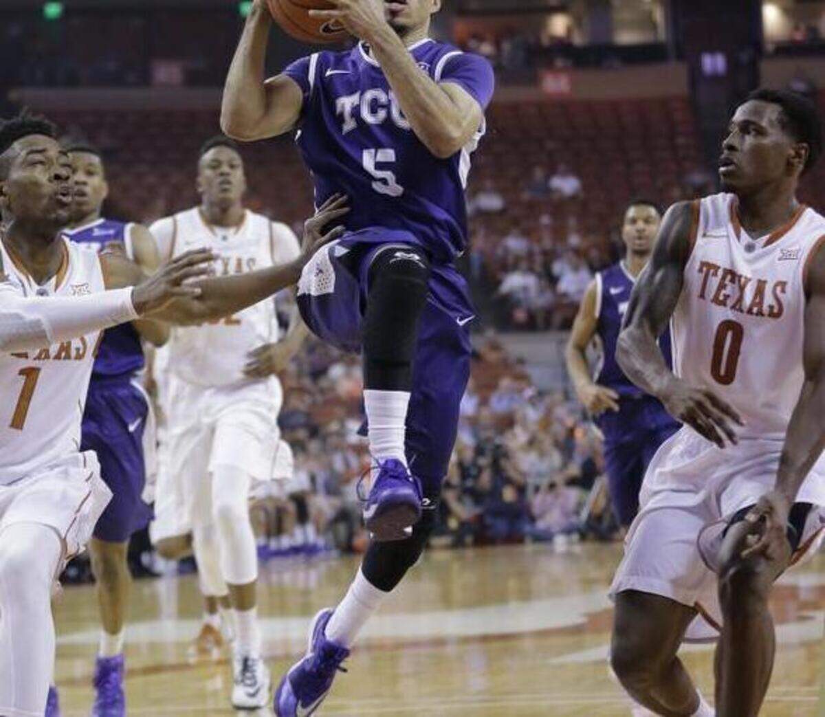 
TCU’s Kyan Anderson, driving to the basket past Texas’ Isaiah Taylor, left, and Kendal Yancy, is the program’s sixth all-time leading scorer. 

