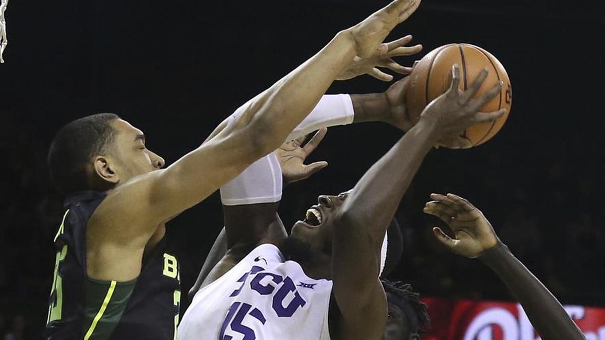 TCU forward JD Miller goes up for a shot against the defense of Baylor forward Tristan Clark during first-half action of a Big 12 game Tuesday at the Ferrell Center in Waco. Miller was among all five starters in double-figure scoring in TCU’s 81-78 overtime victory.