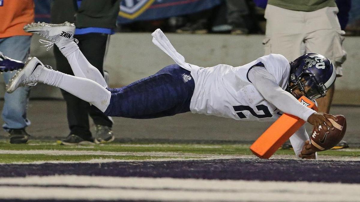 
TCU quarterback Trevone Boykin makes a reach for the pylon with the ball to finish a 14-yard touchdown run against Kansas State. Boykin ran for two scores and passed for two scores to rally the Horned Frogs for a 52-45 victory that kept them unbeaten through six games.
