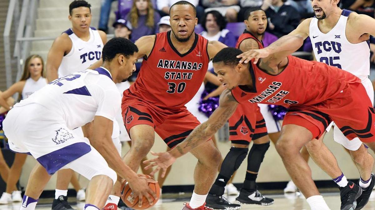 TCU’s Karviar Shepherd, left, steals the ball from Arkansas State’s Nelson Nweke and Donte Thomas in second-half action from Saturday’s game at Schollmaier Arena.