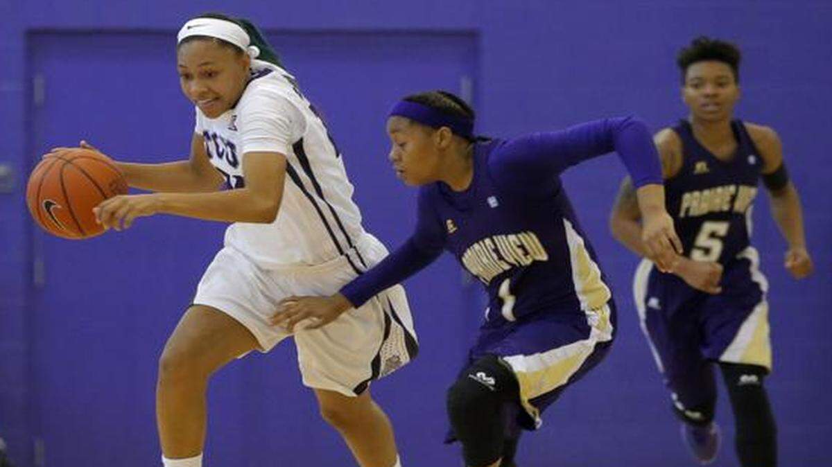 
TCU guard Natalie Ventress steals the ball and makes a break around Jeanette Jackson of Prairie View A&M.
