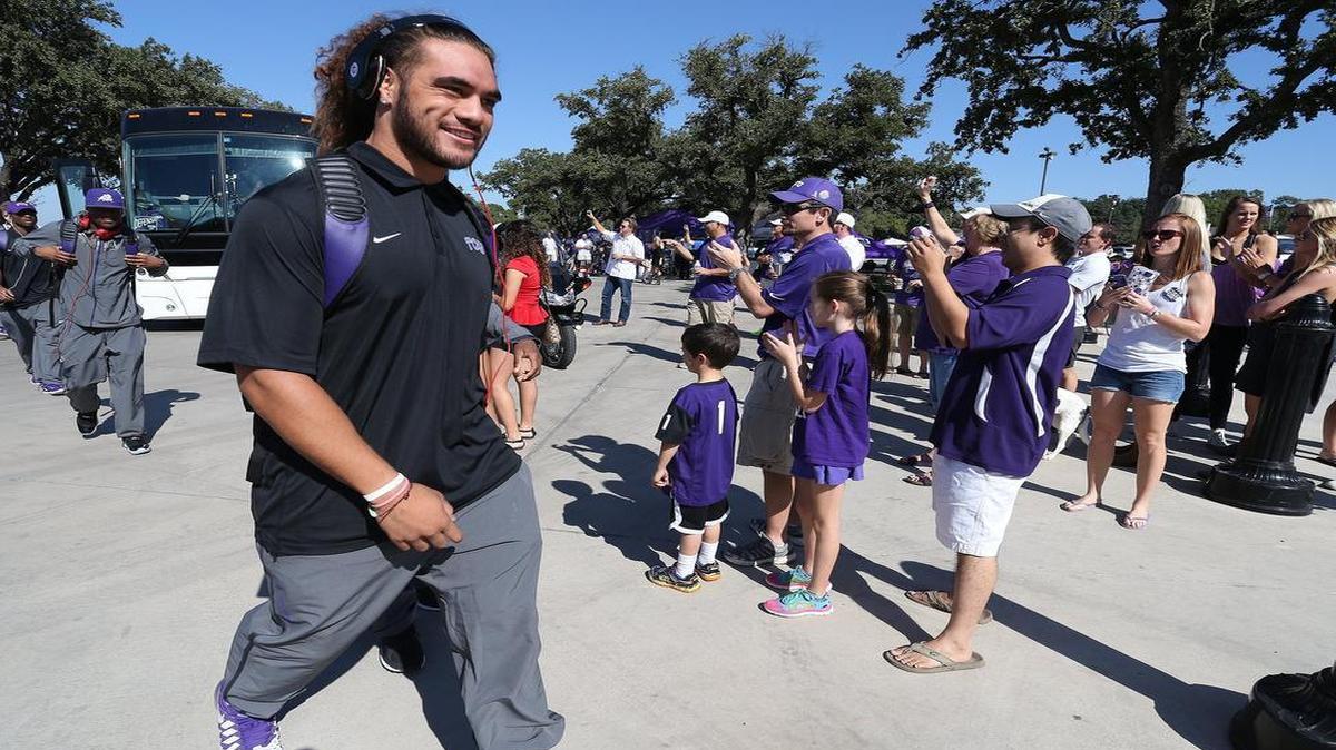 
Defensive end Mike Tuaua smiles after leaving the team bus to enter Amon G. Carter Stadium before last year’s game against Texas Tech. Suspended for three games this season after an incident on Sept. 4 that led to his arrest, Tuaua was cleared by the university this week and has returned to practice.
