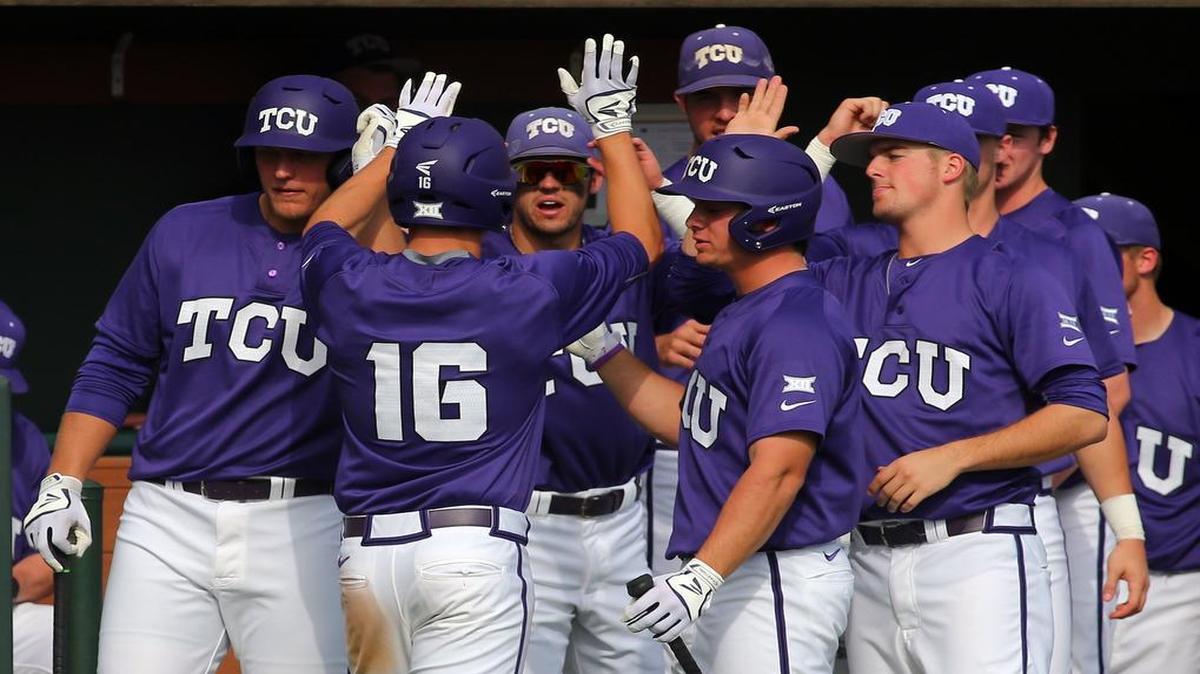 TCU Horned Frogs’ Connor Wanhanen is greeted at the dugout after scoring on a single by Cam Warner in the third inning.