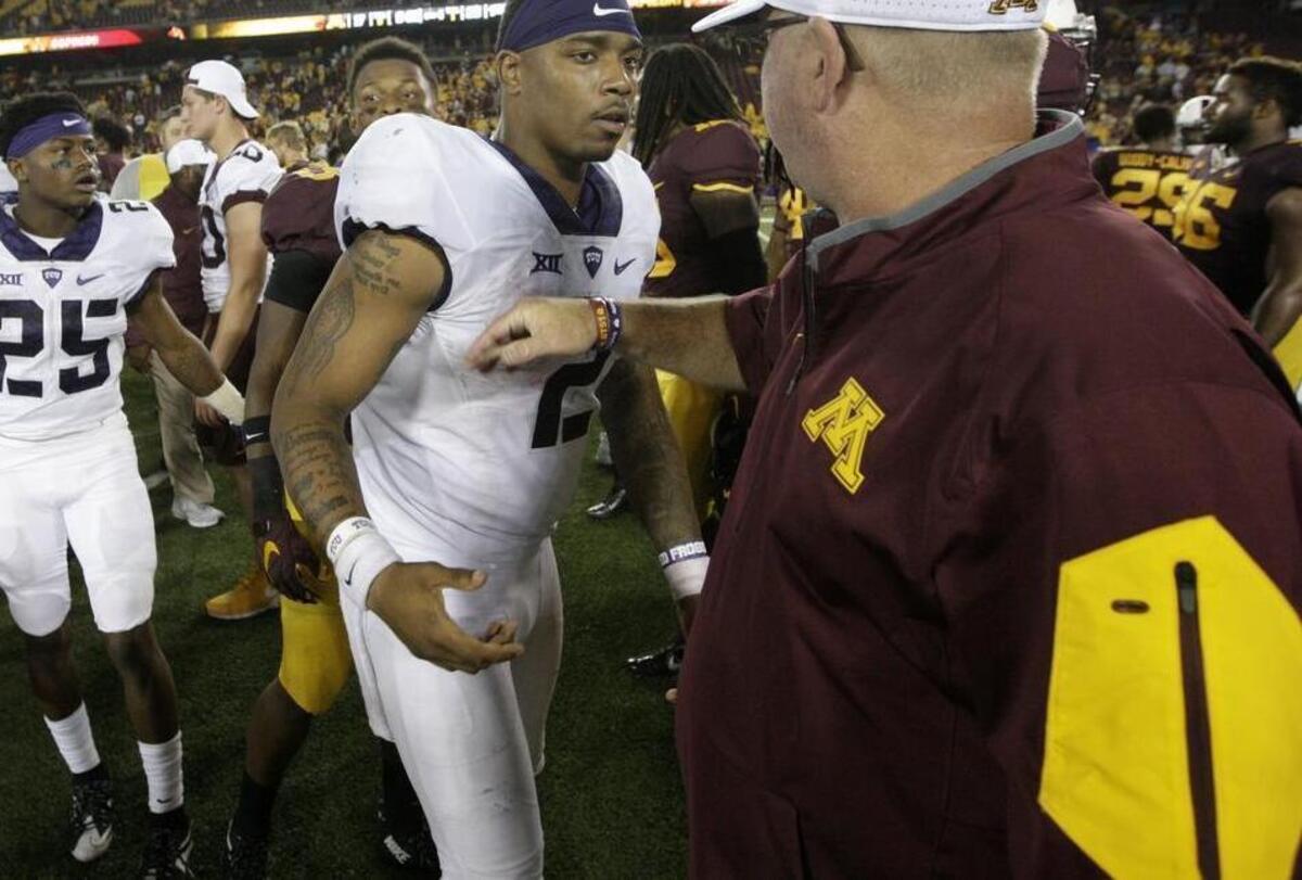 
TCU quarterback Trevone Boykin accepts congratulations from Minnesota coach Jerry Kill following last week’s game. It made Boykin 13-1 since he became the full-time starter last year.

