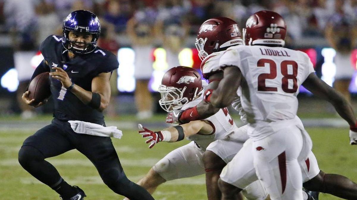 TCU quarterback Kenny Hill moves away from the pursuit of Arkansas defenders during the Sept. 10, 2016, game at Amon G. Carter Stadium.