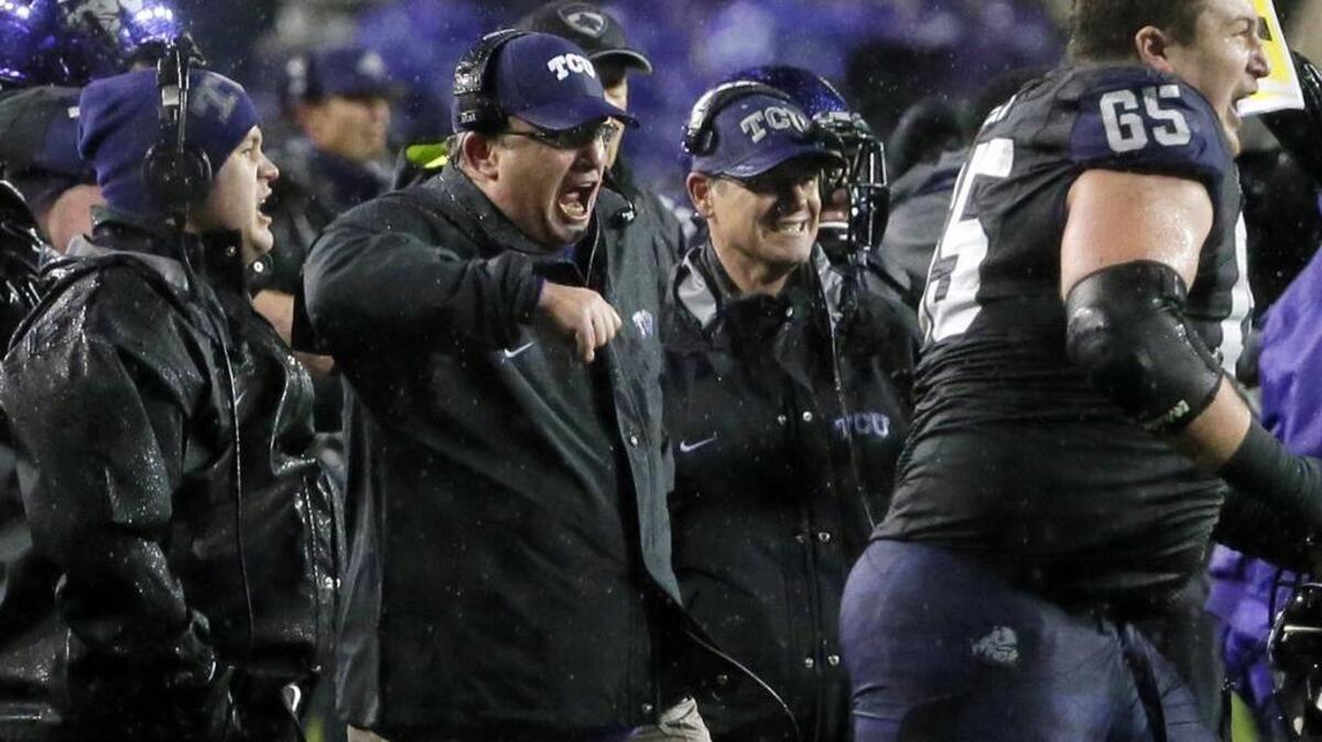 TCU coach Gary Patterson celebrates with the team after the clinching play for a 28-21 double-overtime win against Baylor on Nov. 27, 2015, at Amon G. Carter Stadium.