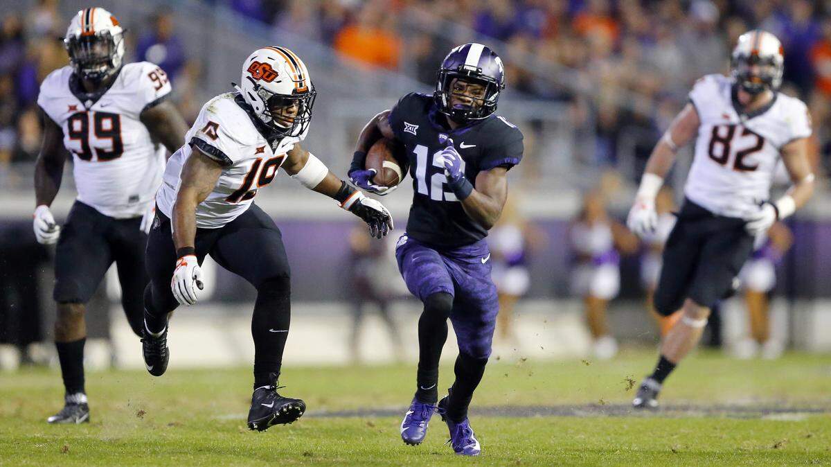 TCU wide receiver Derius Davis (12) breaks away for a long pass reception during the second quarter against Oklahoma State in an NCAA college football game in Fort Worth, Texas, Saturday, Nov. 24, 2018. (Tom Fox/The Dallas Morning News via AP)