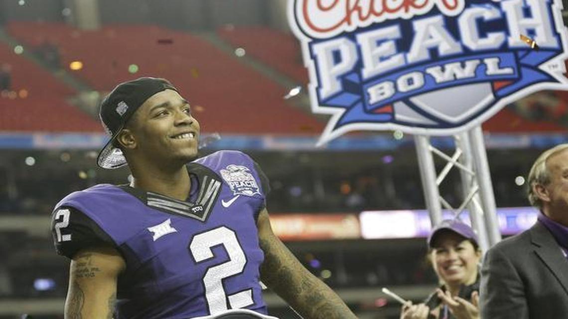 TCU quarterback Trevone Boykin smiles as he walks on stage for the winners’ ceremony at the Peach Bowl last season. The 42-3 victory against Ole Miss gave the Horned Frogs their first Peach Bowl trophy and set a record for the largest margin of victory in the game.