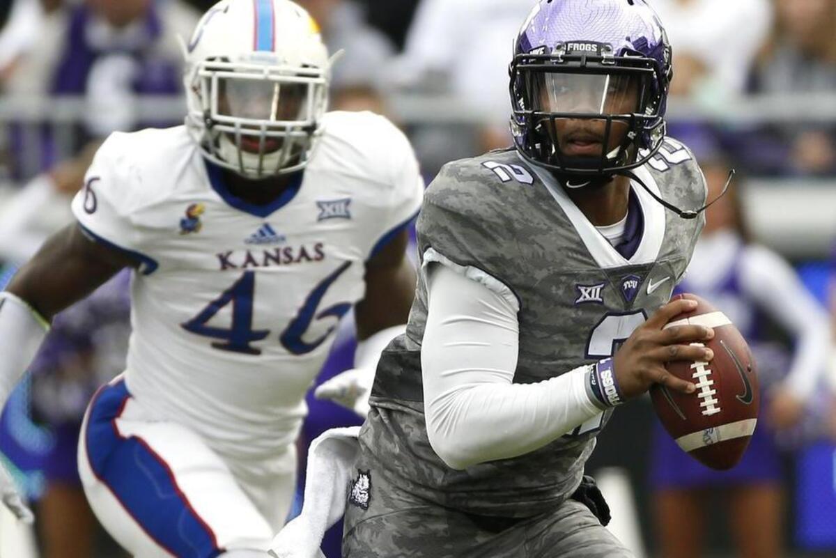 TCU quarterback Trevone Boykin scrambles away from pressure against Kansas. He left the game in the first half after getting hurt on a first-quarter scramble, and backup quarterback Bram Kohlhausen took over with a 14-10 deficit.