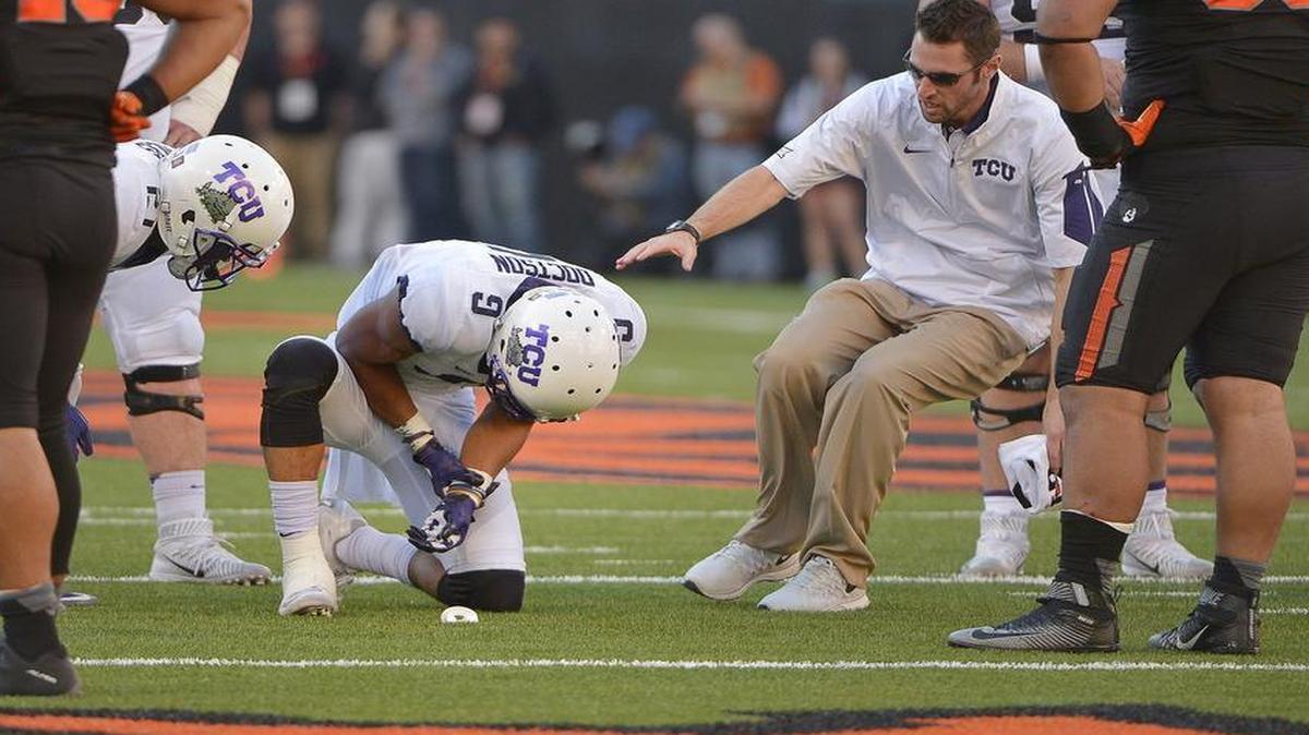 TCU receiver Josh Doctson holds his wrist after getting hurt on a second-quarter play at Oklahoma State. He left the game and did not return.