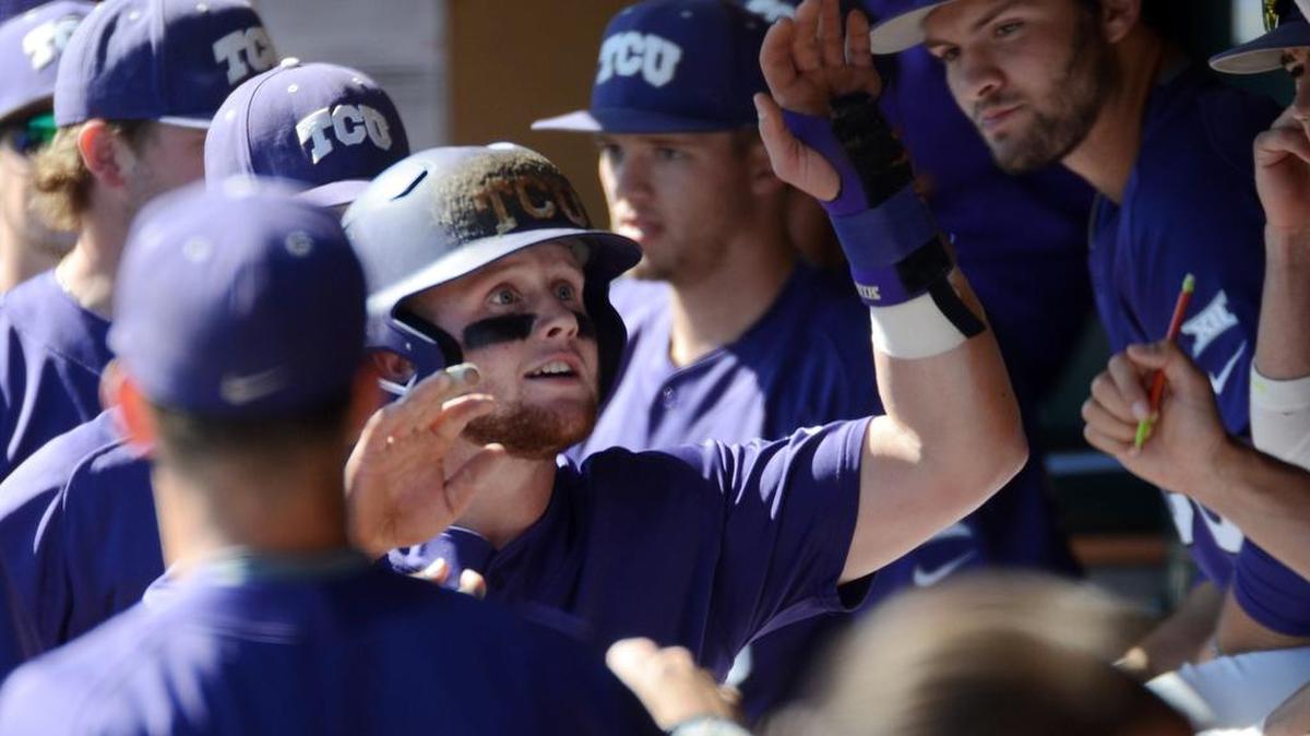 TCU catcher Evan Skoug gets congratulations in the dugout after scoring in a March 19 game against West Virginia at Lupton Stadium.
