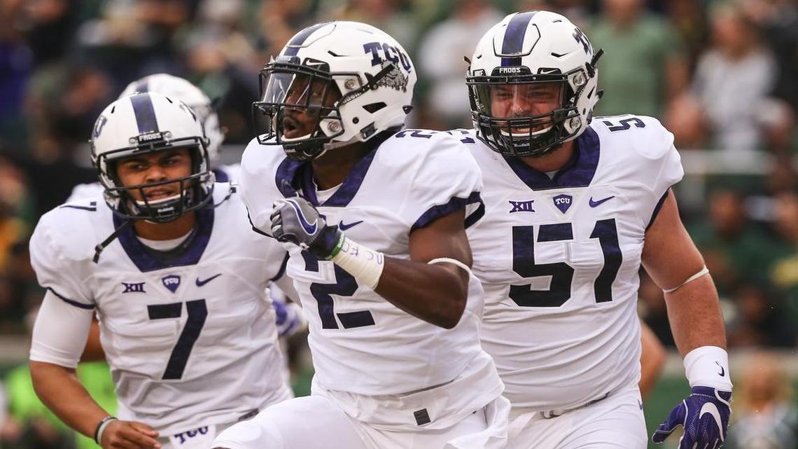 TCU receiver Taj Williams (center) is joined in celebrating his touchdown catch by quarterback Kenny Hill (left) and center Austin Schlottman in a Nov. 5 game at Baylor.
