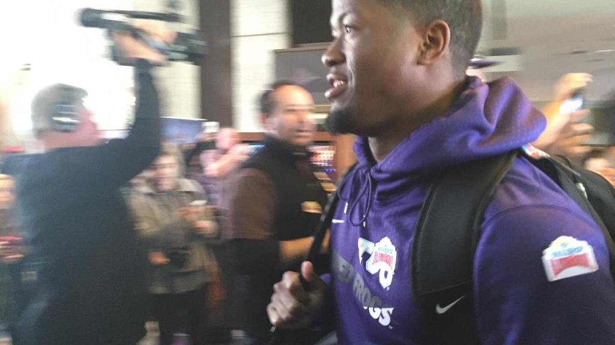 TCU running back Aaron Green walks among fans in the lobby upon arrival at the team hotel in San Antonio. Green is one of three San Antonio natives on the Horned Frogs roster, and he will play his final college game in his hometown.