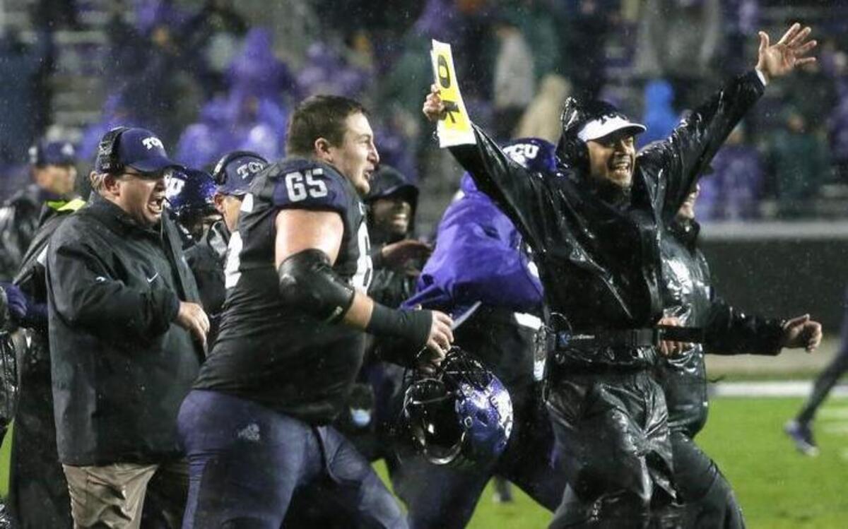TCU coaches and players from the sideline run on the field amid pouring rain after a 28-21 double overtime win against Baylor on Nov. 27. The Horned Frogs finished the regular season 10-2, hitting the December recruiting season on a high. They landed six junior-college players, losing only one targeted player.