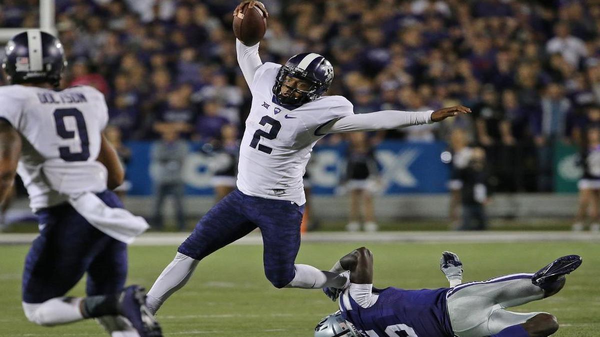 
TCU quarterback Trevone Boykin moves to avoid a tackle attempt by Kansas State’s Jesse Mack during a fourth-quarter drive. Boykin scored two touchdowns and threw a touchdown pass in the second half of the Horned Frogs’ 52-45 victory last week.
