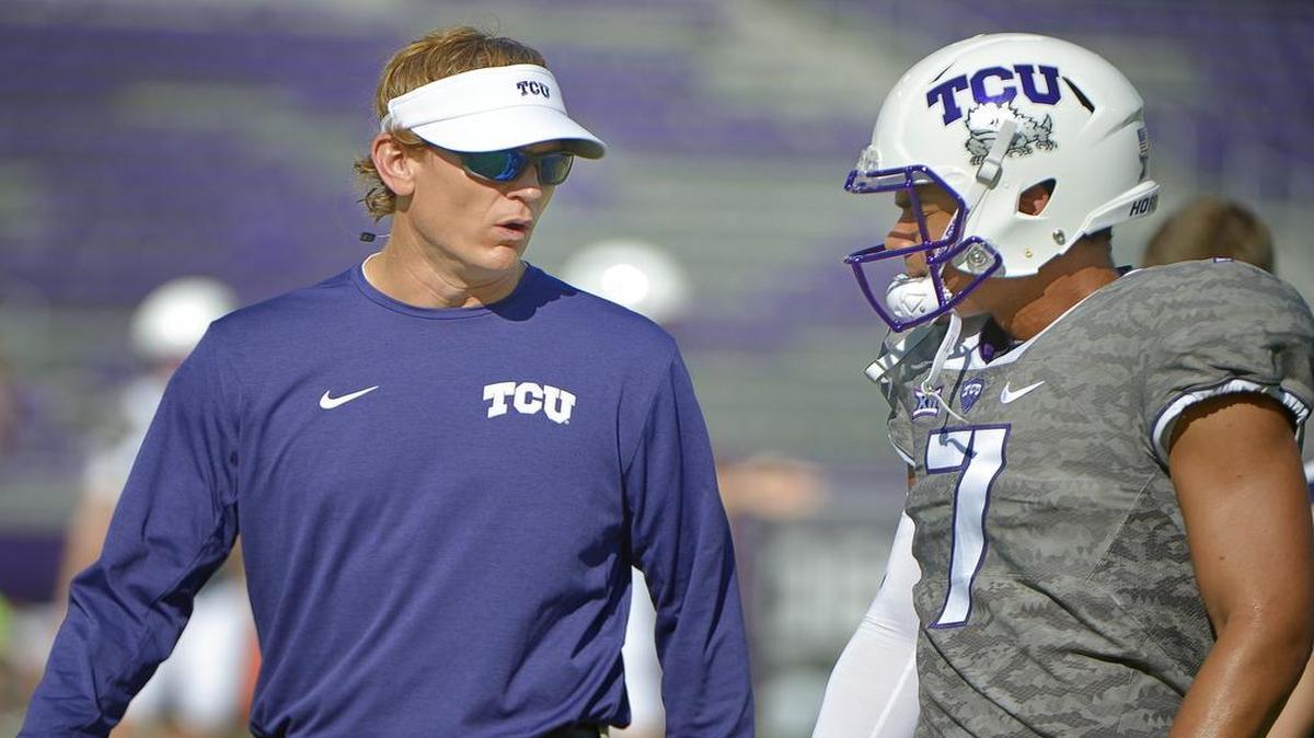 TCU’s Sonny Cumbie talks with quarterback Kenny Hill before a Sept. 17 game against Iowa State at Amon G. Carter Stadium. Cumbie will be offensive coordinator for the Horned Frogs in 2017, head coach Gary Patterson confirmed Friday.
