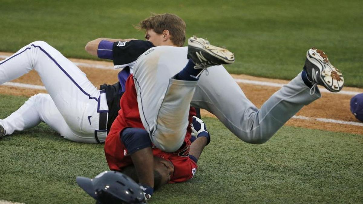 Dallas Baptist left fielder Daniel Sweet and TCU first baseman Connor Wanhanen tumble after a collision on the first-base line in the second inning. They hit as Wanhanen tracked down a pop up. Both players remained in the game.