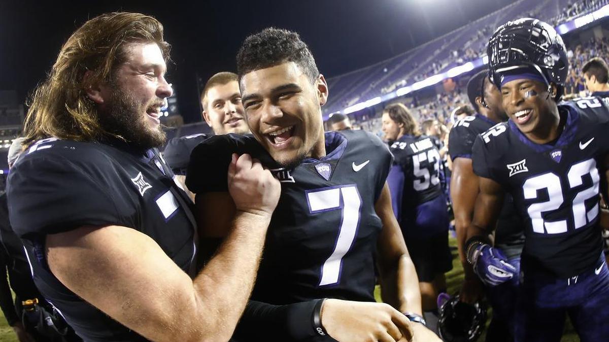 Kenny Hill celebrated with teammates, including offensive lineman Nick Cominos, left, after No. 4 TCU crushed Kansas 43-0 on Saturday at Amon G. Carter Stadium.