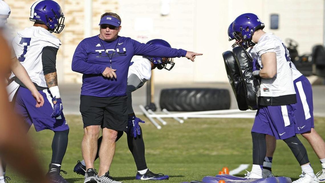 TCU coach Gary Patterson works with linebacker Arico Evans and other defensive players during the first spring practice in 2017.
