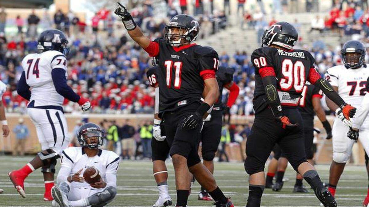 
Euless Trinity  defensive end Tipa Galeai (11) celebrates a sack of Allen  quarterback Kyler Murray during the state playoffs Dec. 6 at Apogee Stadium in Denton. 
