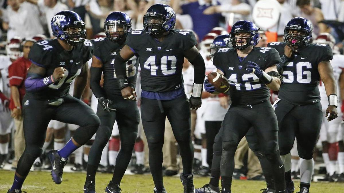 The TCU defense, led by ends Josh Carraway (94) and James McFarland (40) and linebacker Ty Summers (42), celebrates a third-down incompletion in the fourth quarter against Arkansas last week.