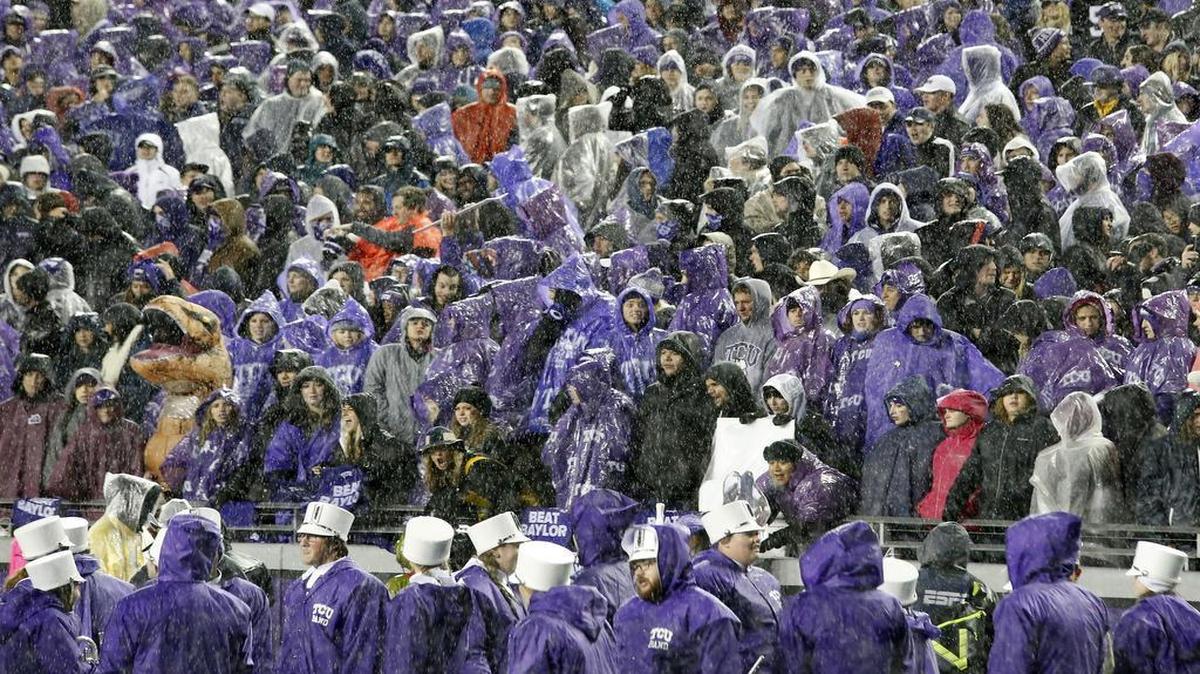 In a sea of rain gear, the crowd at Amon G. Carter Stadium waits for the start of the game between TCU and Baylor. A lightning strike delayed the kickoff by about 45 minutes.
