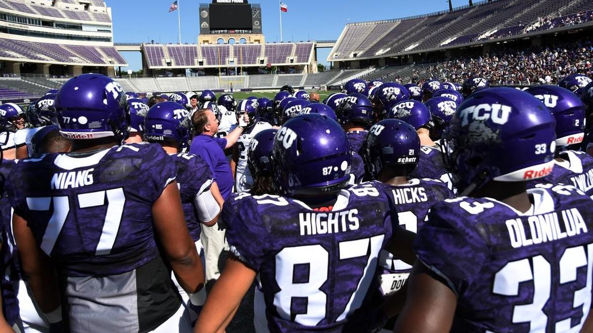 The TCU Horned Frogs gather around coach Gary Patterson for instructions before the start of the spring game April 8 at Amon G. Carter Stadium.
