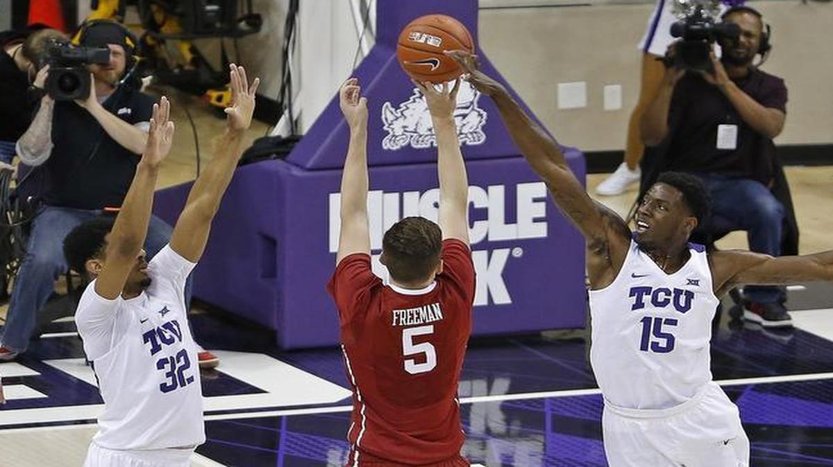 JD Miller, right, finishes off TCU’s block party with a rejection of Oklahoma’s Matt Freeman in the final seconds Tuesday. The Horned Frogs finished with 13 blocks.