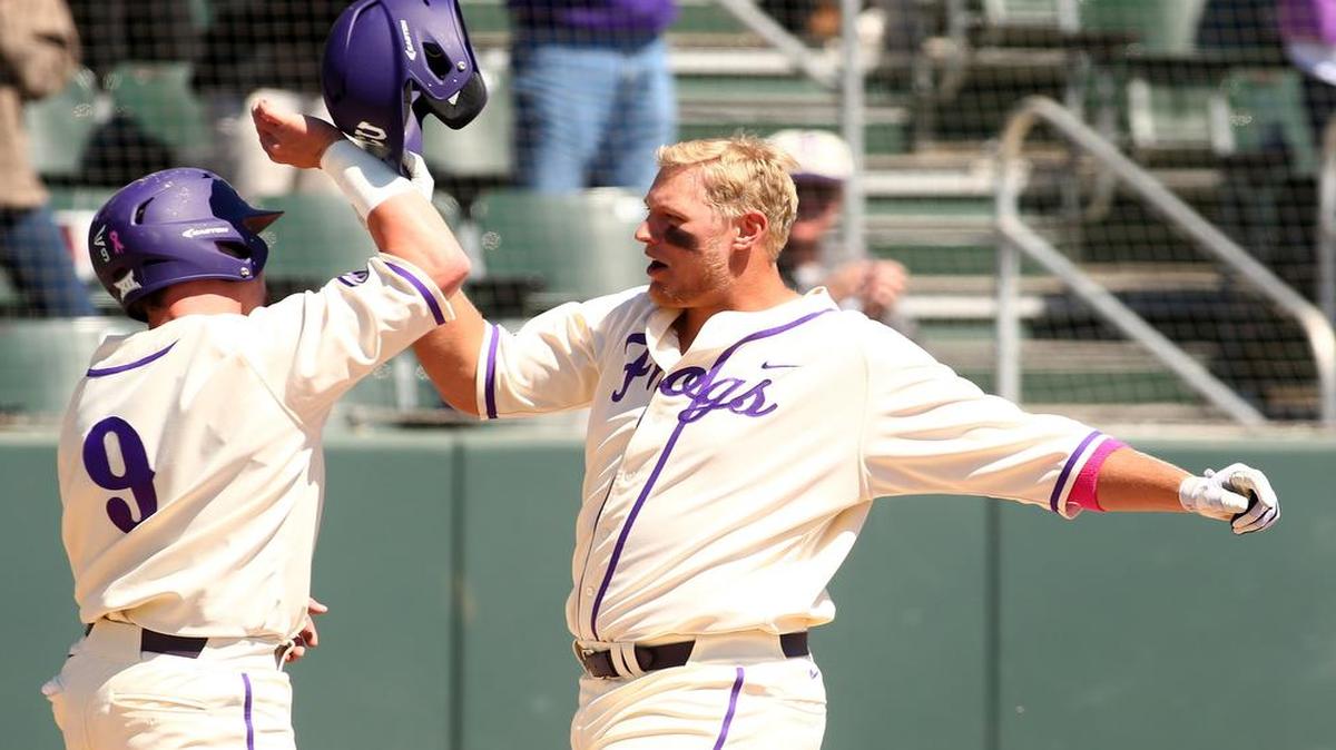TCU’s Luken Baker (right) greets Evan Skoug at the plate after hitting a first-inning grand slam against West Virginia in a March 20 game. Baker drove in five runs in that game, and he matched it Wednesday against Baylor at the Big 12 tournament in Oklahoma City.