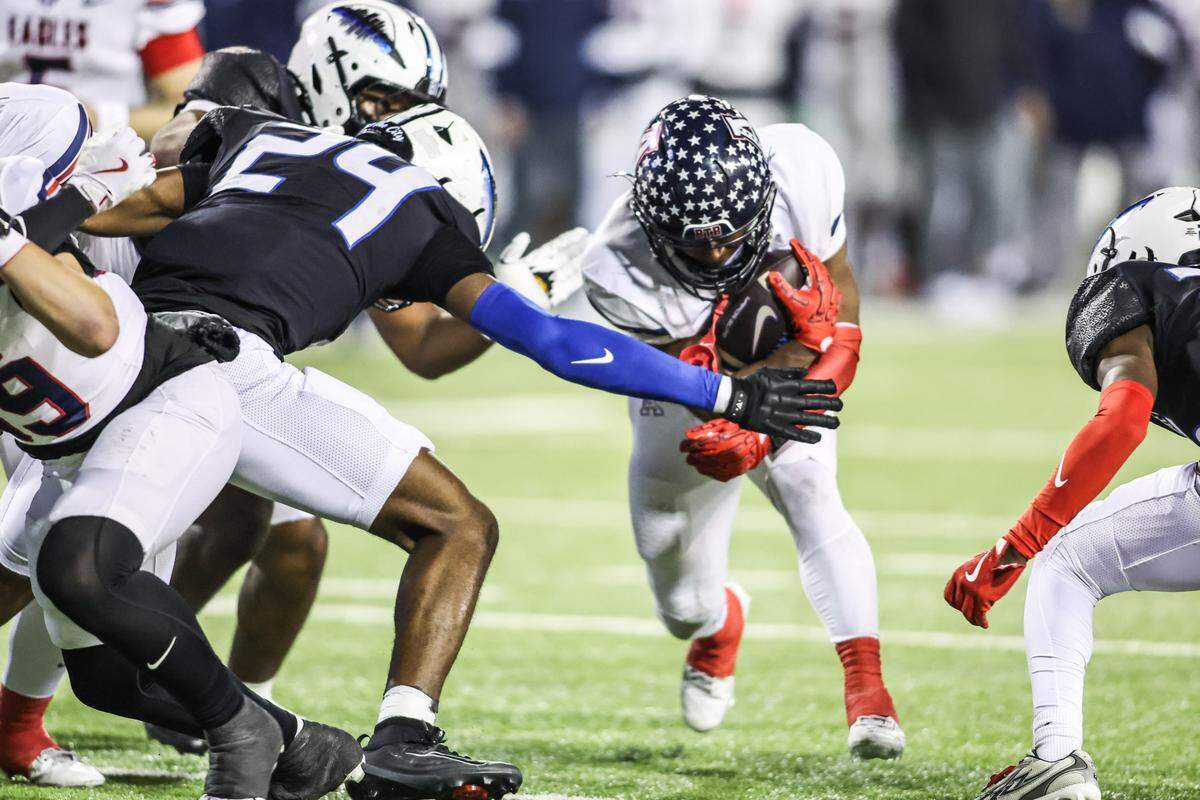 North Crowley’s Jurwone Irvin (24) tackles Allen running back Lyndon Spriggs during the Class 6A Division I regional final Friday.