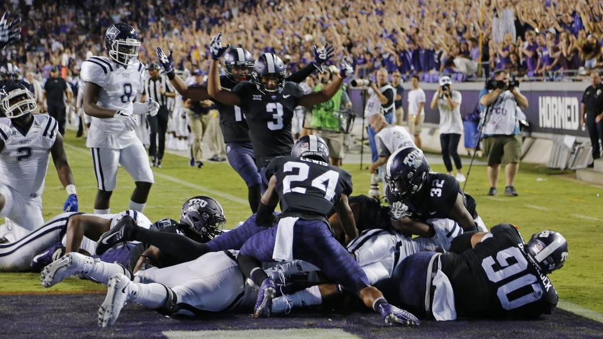 TCU players celebrate an interception return for a touchdown by safety Ridwan Issahaku against Jackson State on Sept. 2 at Amon G. Carter Stadium.